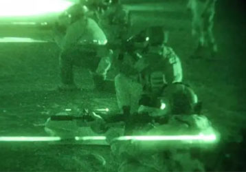 How do night vision goggles use light that is invisible to the human eye to turn night into day?